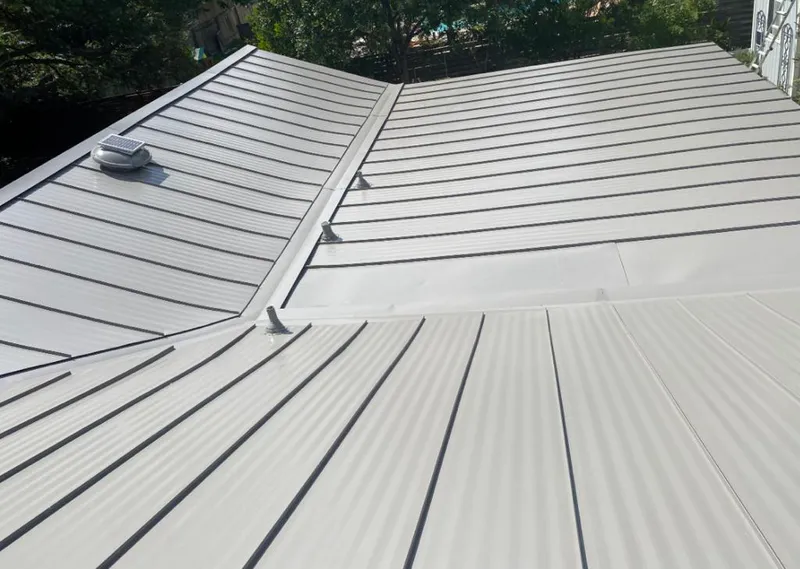 Solar attic fan installed on a metal roof for Roof Ventilation in Moraine